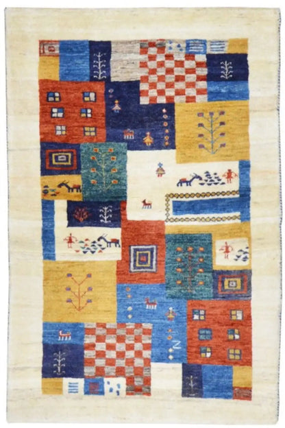 Gabbeh rug with a patchwork pattern in blue, red, and yellow on a light background