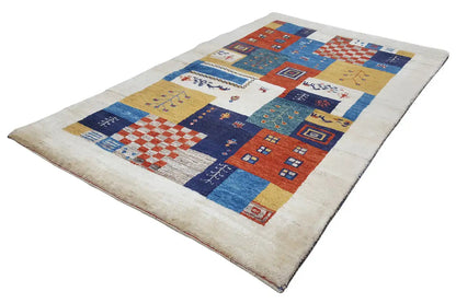 Gabbeh rug with colorful tiles and border, blue-red tones on a light background