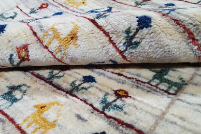 Carpet pile in detail: beige pile with multicolored embroidered motifs and red lines