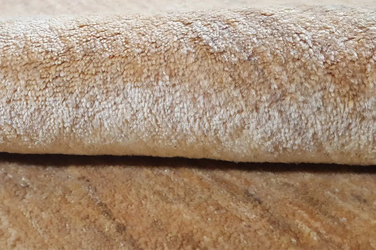 Close-up: beige carpet pile with a dense, subtly mottled texture
