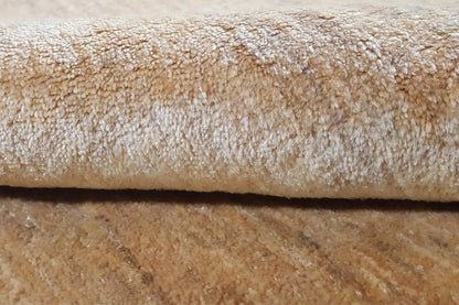 Close-up: beige carpet pile with a dense, subtly mottled texture