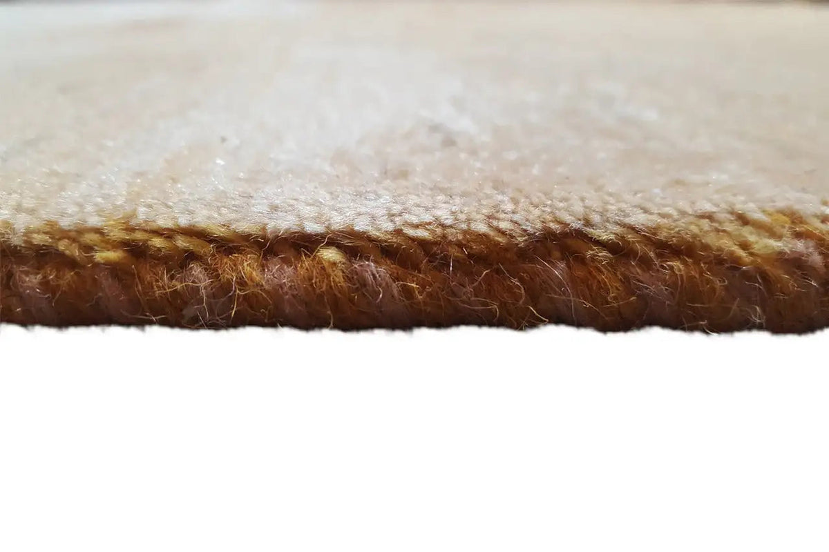 Carpet edge with beige pile and brown backing thread, side detail