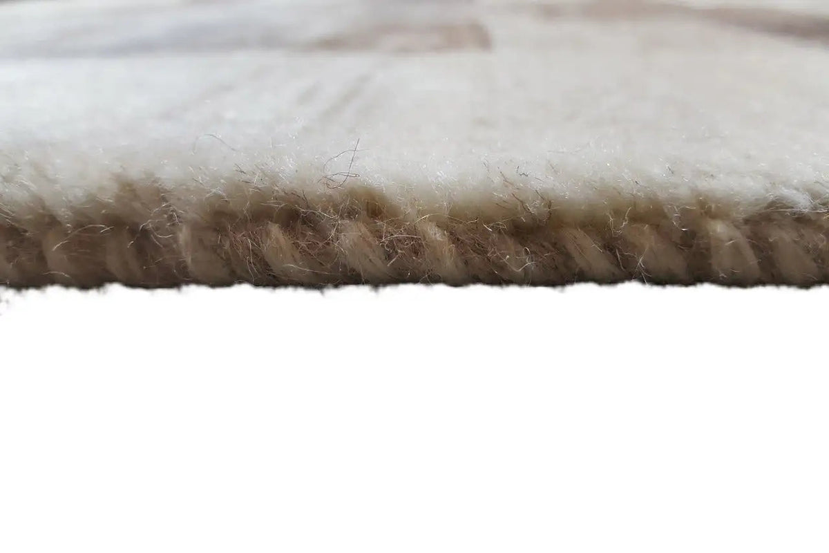 Rug edge with short brown fringes and beige woven fabric