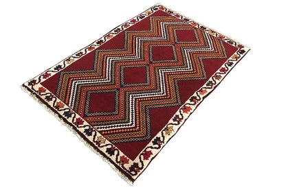 Red-brown Gabbeh rug with a zigzag pattern and diamonds, arranged diagonally