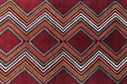 Gabbeh rug detail: reddish-brown area with zigzag and diamond patterns