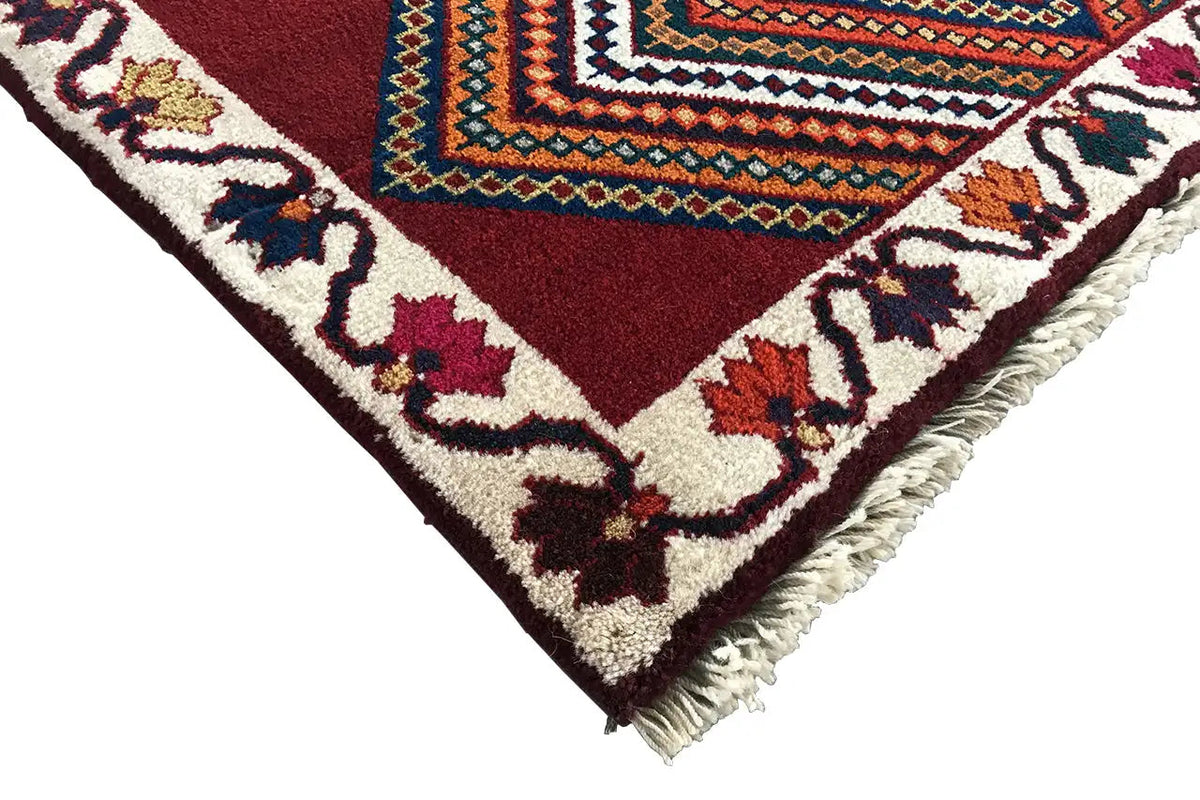 Gabbeh rug corner with fringe, red-brown ornamental pattern with tendrils