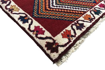 Gabbeh rug corner with fringe, red-brown ornamental pattern with tendrils
