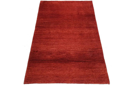Red carpet in three-quarter view, smooth pile surface without a pattern, rectangular