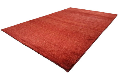 Red Gabbeh rug from the corner, low pile with a uniform texture