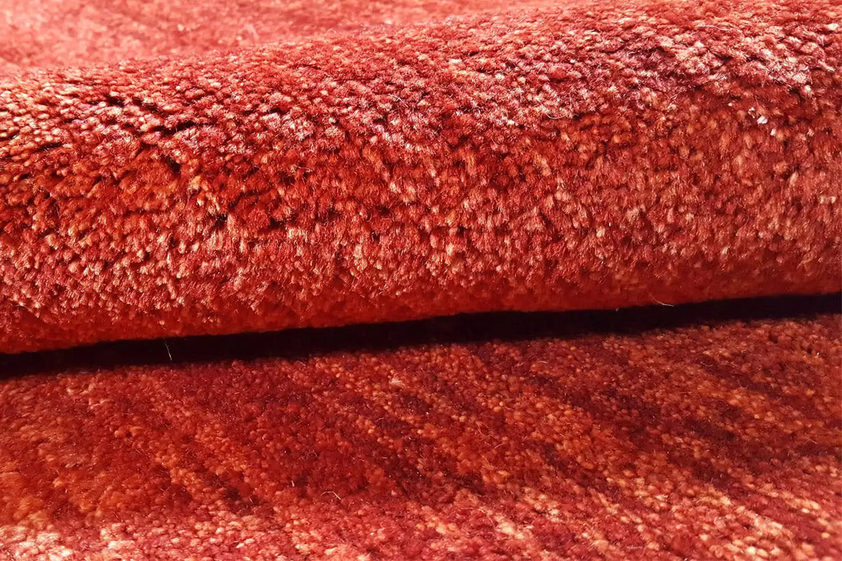 Close-up: red carpet pile with a dense, velvety surface