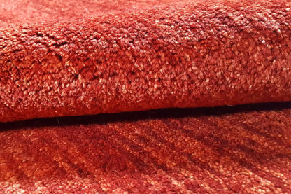 Close-up: red carpet pile with a dense, velvety surface