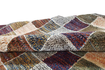 Gabbeh rug detail view: multicolored square segments with dense pile