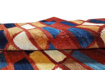 Gabbeh rug close-up: dense woven pattern of colored squares in blue and red