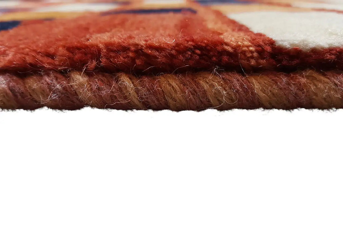 Gabbeh rug close-up of the rug edge with a soft reddish-brown pile