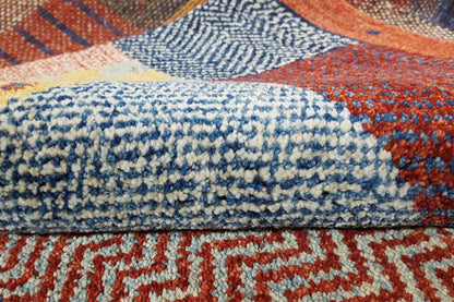Gabbeh rug close-up: blue-white and orange patterns in the dense pile