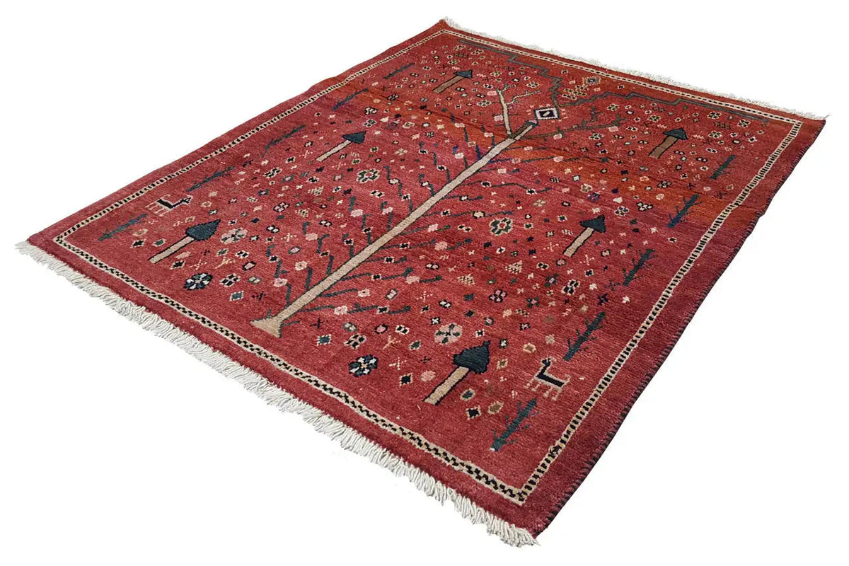 Reddish-brown Gabbeh rug with a tree motif, ornaments, and fringes along the edge