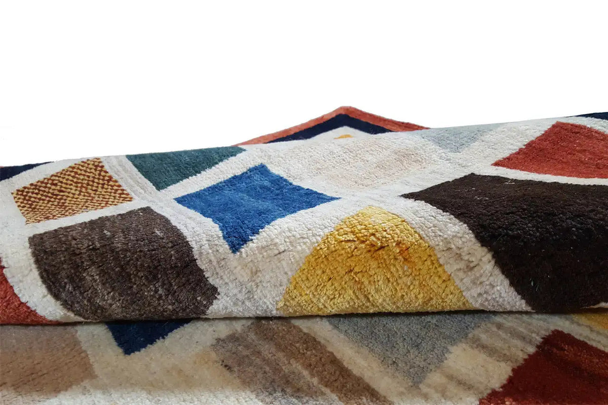 Gabbeh rug (185x135 cm) close-up: flat patterned sections, multicolored texture and pile