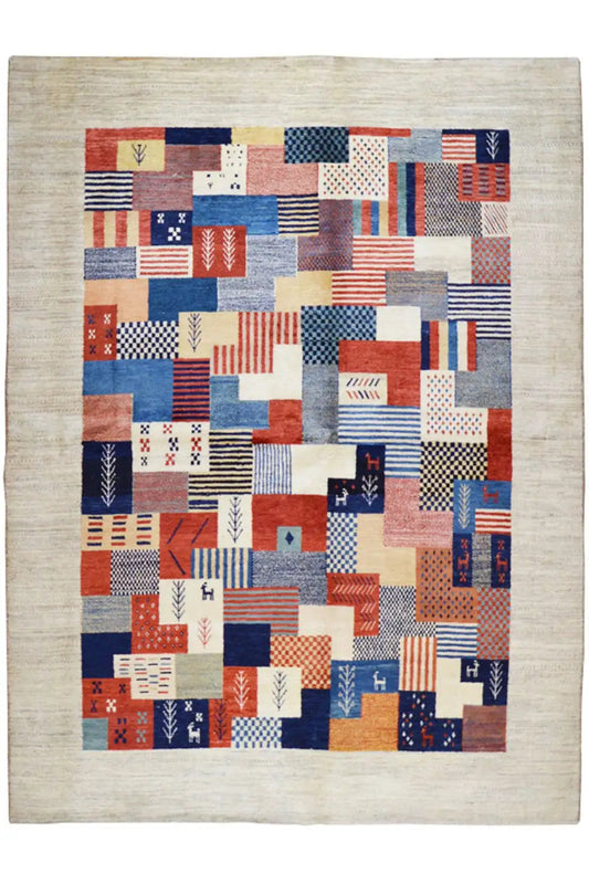 Gabbeh rug with patchwork design in red, blue, and beige, rectangular