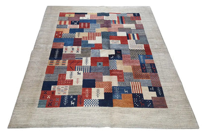 Rug with a geometric patchwork pattern in red, blue, white, and beige