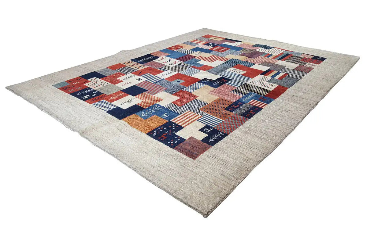 Patchwork-style rug, made of many red and blue squares on a light background