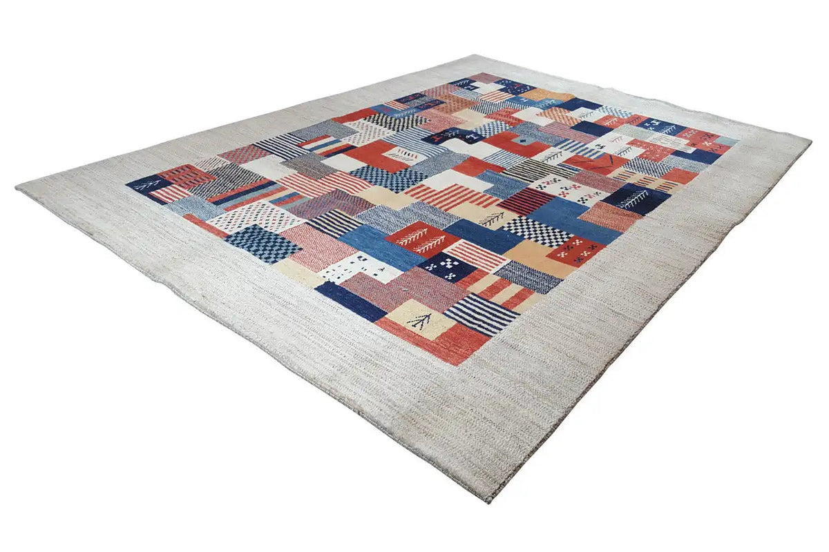 Rug with a square patchwork pattern in red, blue, and white on a beige border