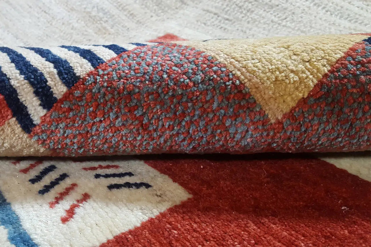 Close-up: carpet pile with a patchwork design in blue, red, and beige