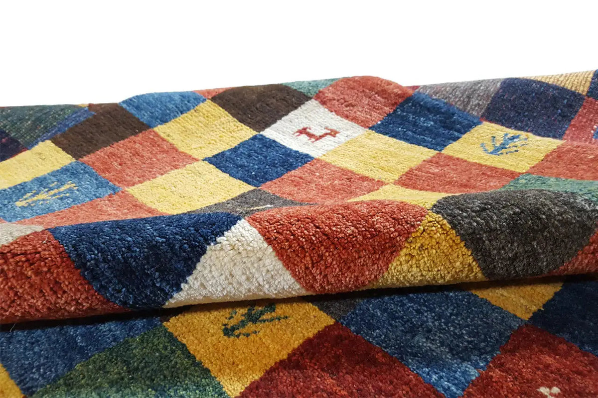 Gabbeh rug detail: multicolored checkerboard squares with a short, dense pile surface