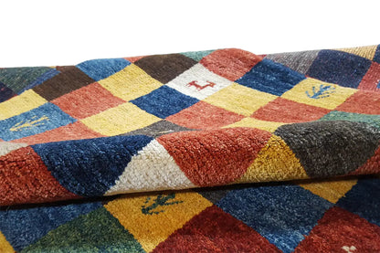 Gabbeh rug detail: multicolored checkerboard squares with a short, dense pile surface
