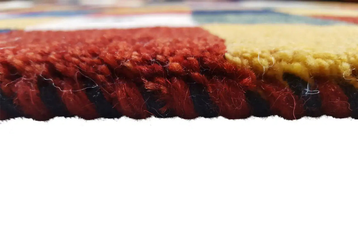 Gabbeh rug edge view with a short fringed finish and multicolored pattern