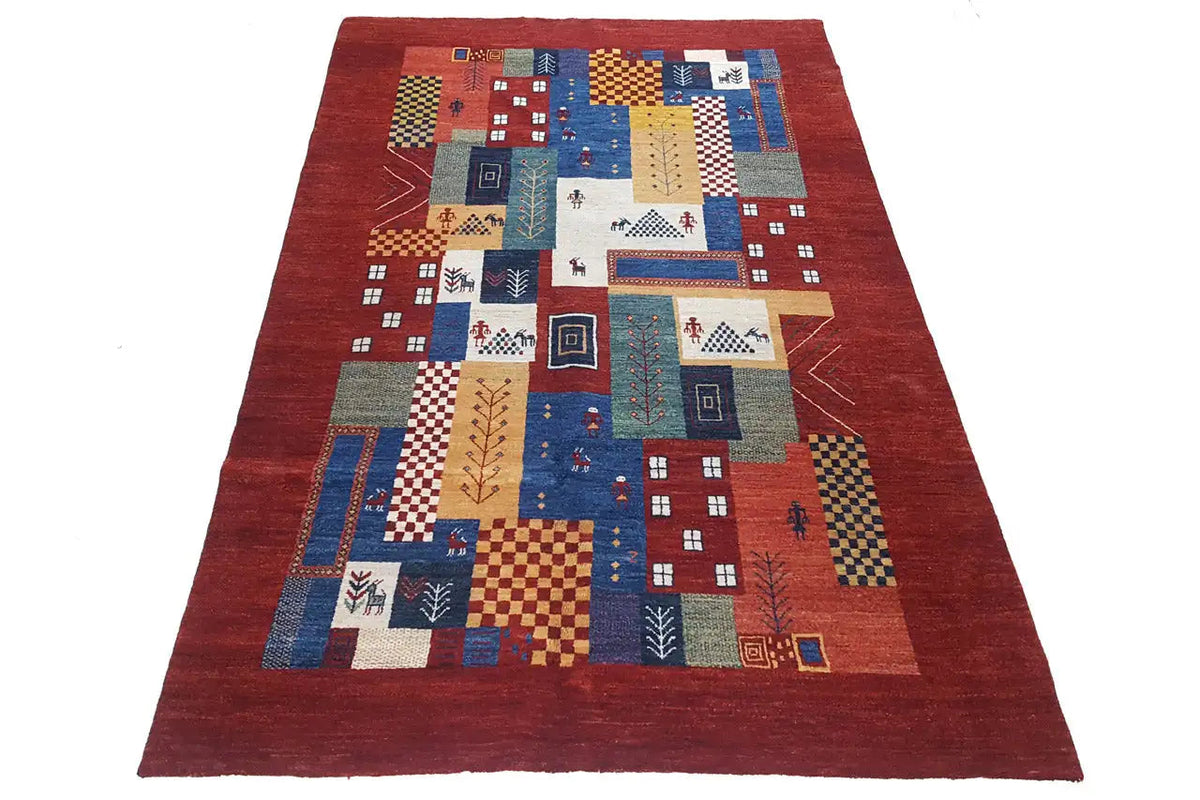 Gabbeh rug with a red border and central geometric patchwork, rectangular