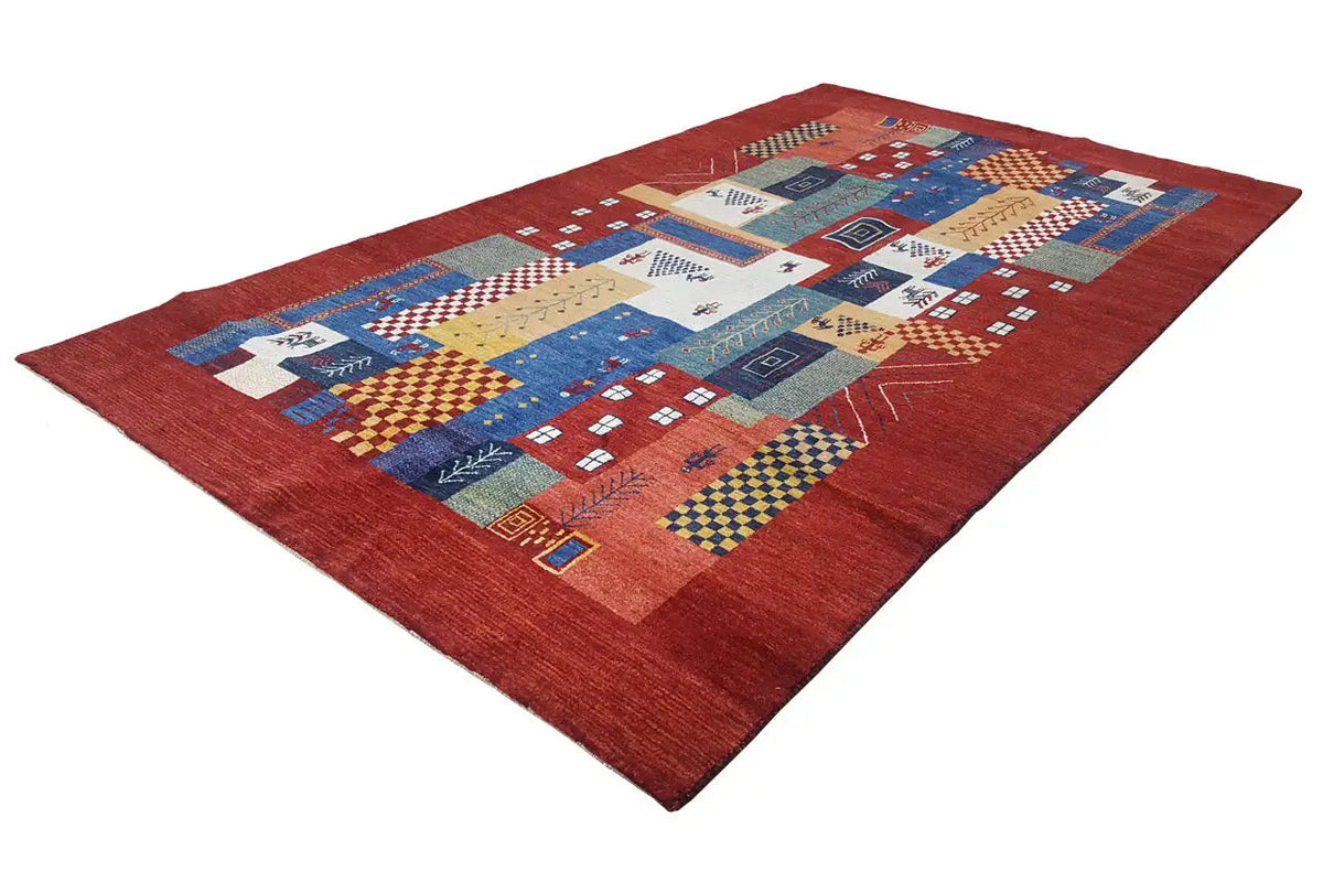 Red Gabbeh rug with blue and yellow pattern elements and border