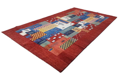 Red Gabbeh rug with blue and yellow pattern elements and border