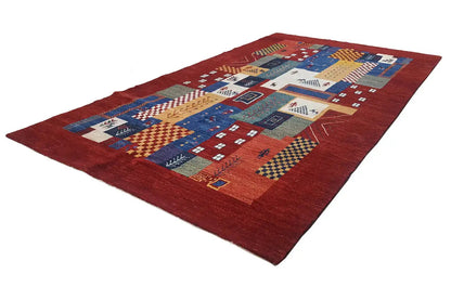 Gabbeh rug with a red background, multicolored patterned border, and geometric motifs
