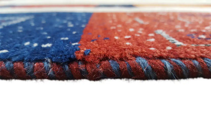 Gabbeh rug edge view: pile with fringe, blue-red contrast
