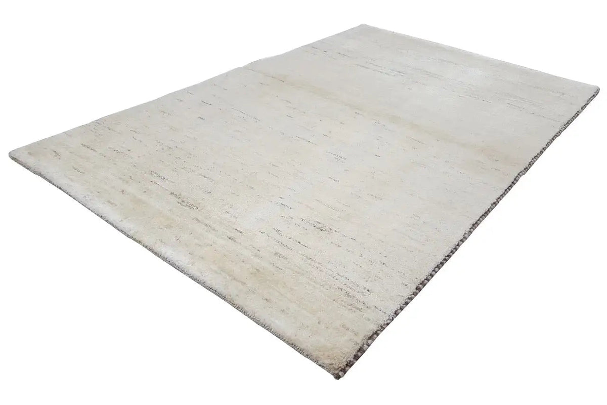 Beige rectangular Gabbeh rug with an even, subtly textured surface.