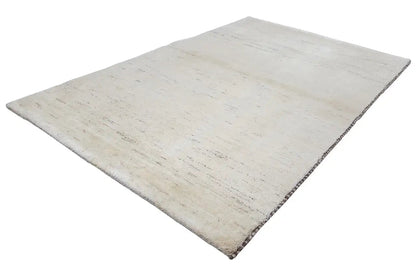 Beige rectangular Gabbeh rug with an even, subtly textured surface.