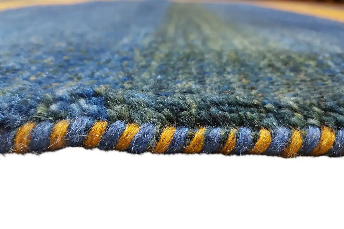 Rug edge with fringes, blue base and ochre-green stripes