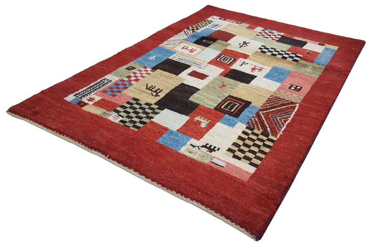 Red Gabbeh rug with geometric patchwork and border