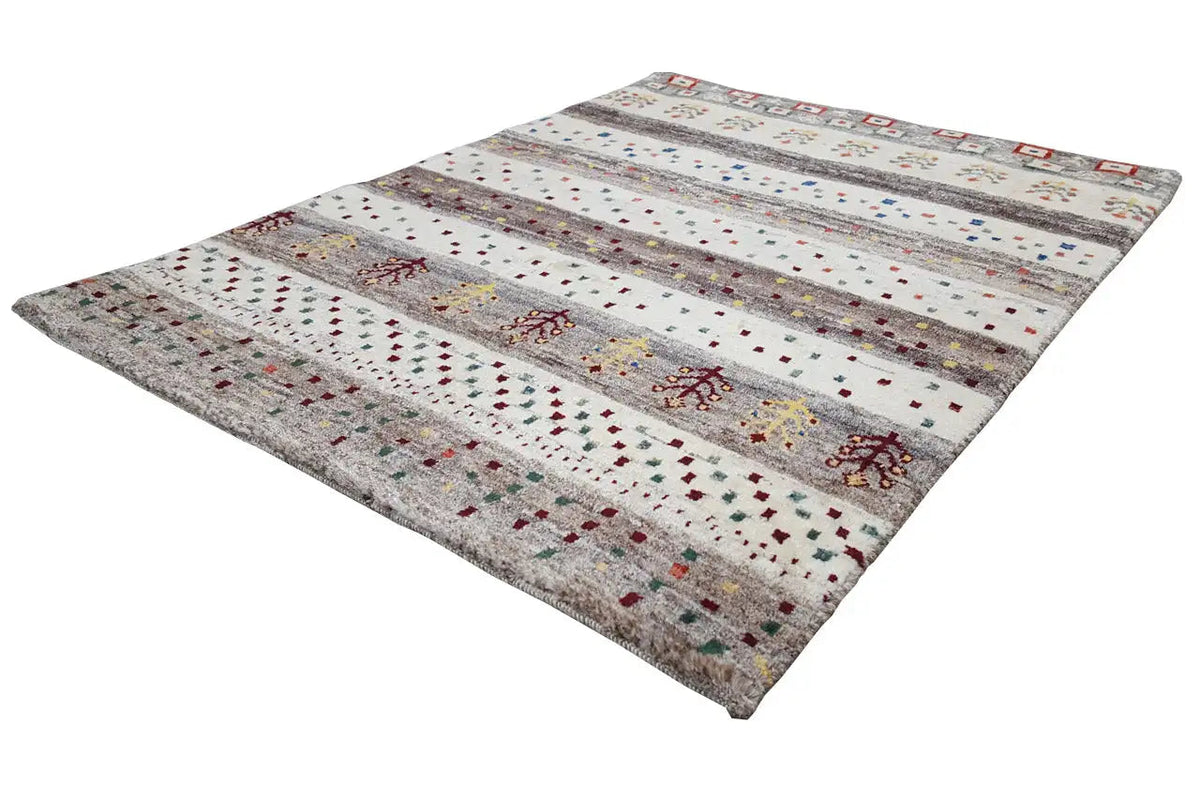 Gabbeh rug with an all-over striped layout and floral ornaments on a light background