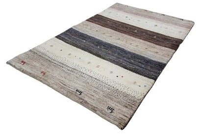 Gabbeh rug laid flat, horizontal stripes in gray, dark brown, and beige