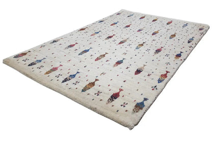 Cream Gabbeh rug with a colorful figure pattern, rectangular, pile edge visible