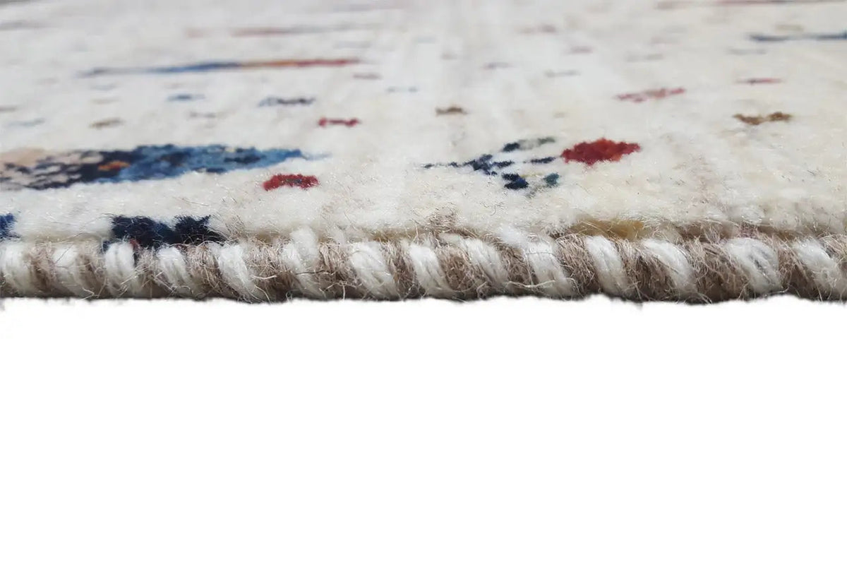 Gabbeh rug: edge fringe and pile strands, colorful pattern along the border