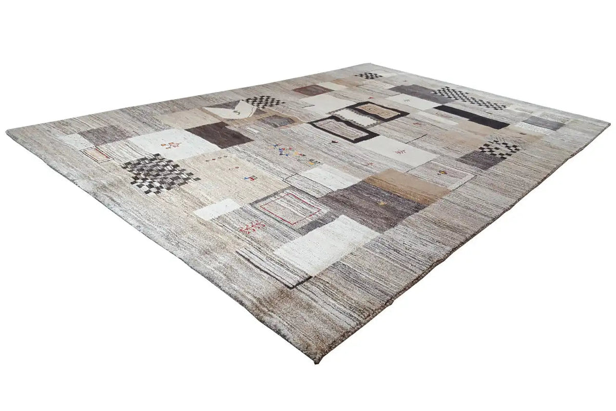 Gabbeh rug with a diagonal patchwork pattern in light gray and beige