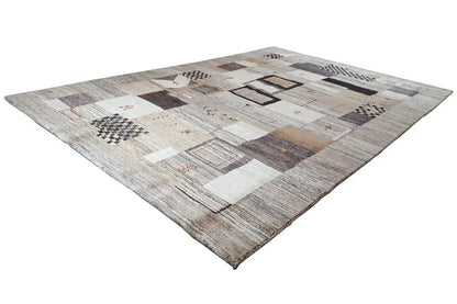 Gabbeh rug with a diagonal patchwork pattern in light gray and beige