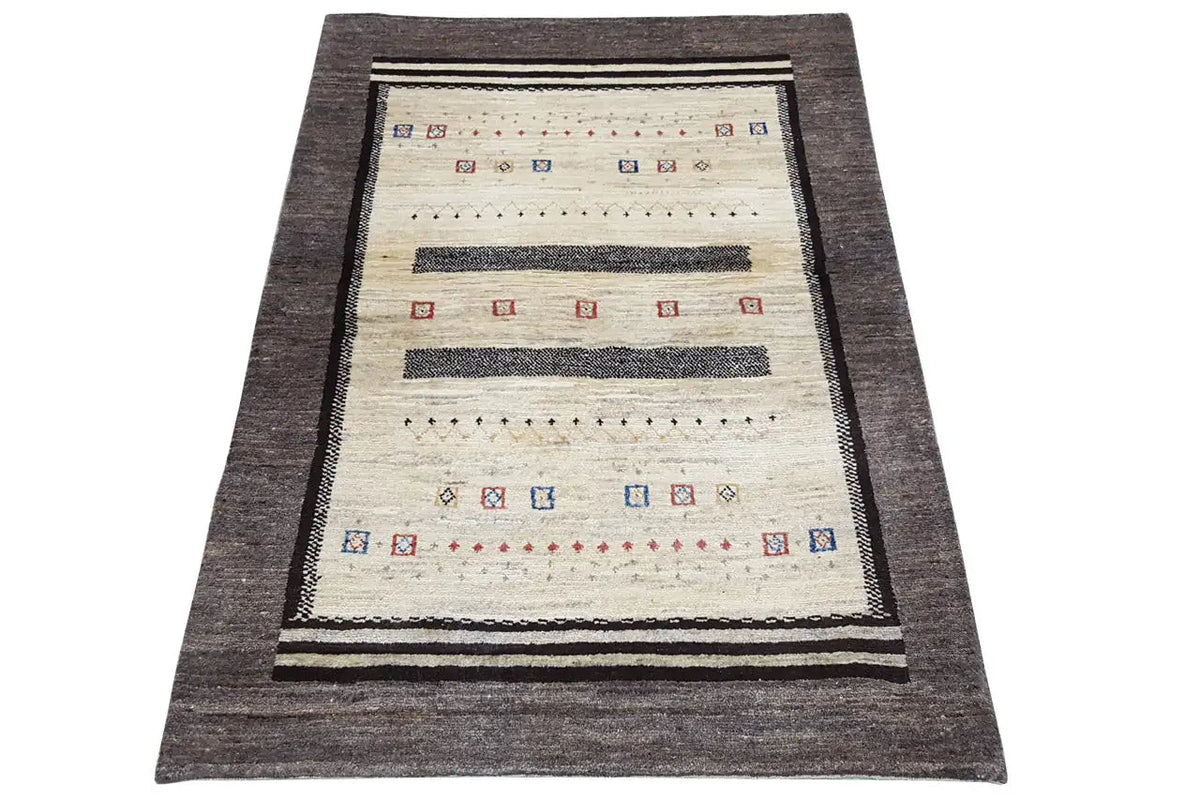 Gabbeh rug in front view with a cream-colored background, dark gray border and trim