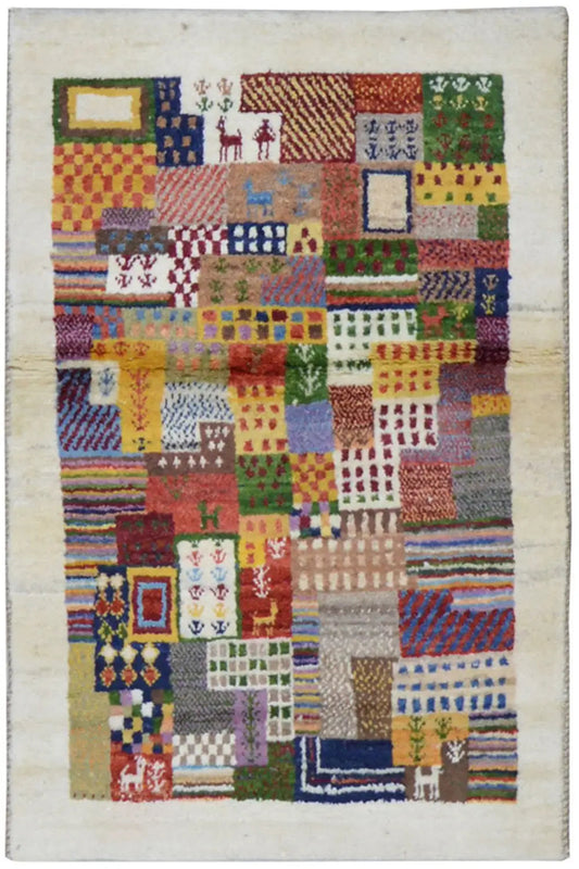 Gabbeh rug with a colorful patchwork pattern on a light background