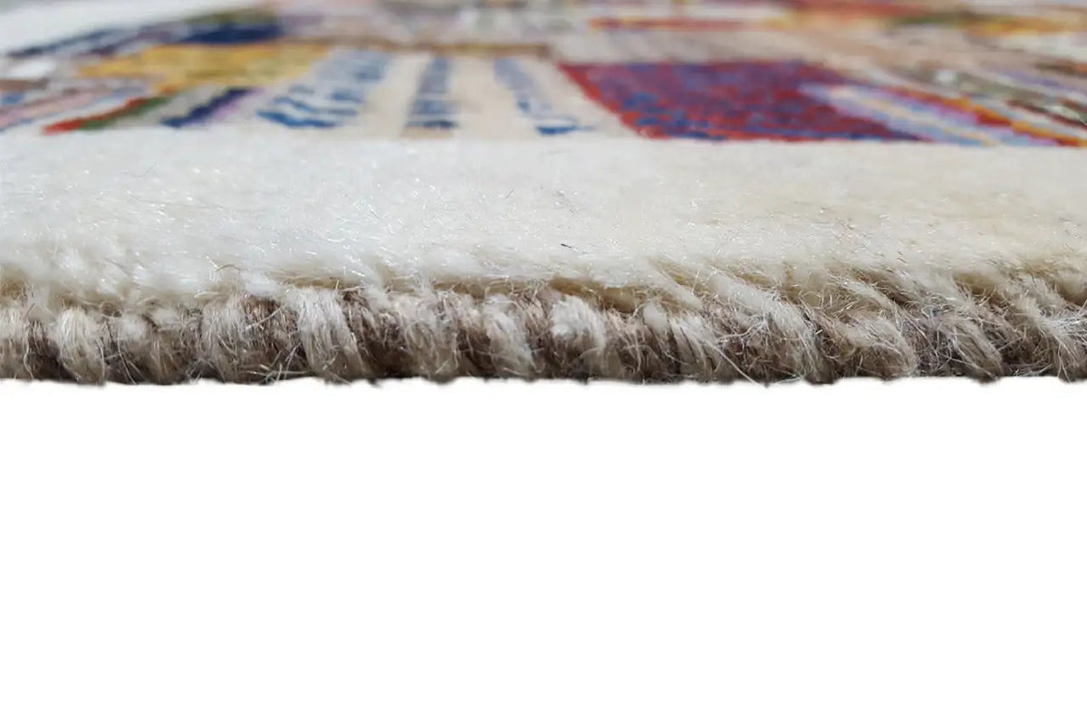 Gabbeh rug: fringes along the edge, dense beige pile with patterned area