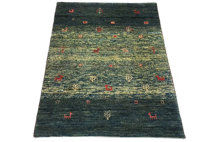 Gabbeh rug 86x62 cm, dark green pile with small red motifs and animals.