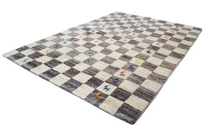 Gabbeh rug with a white-gray checked pattern and colorful accents