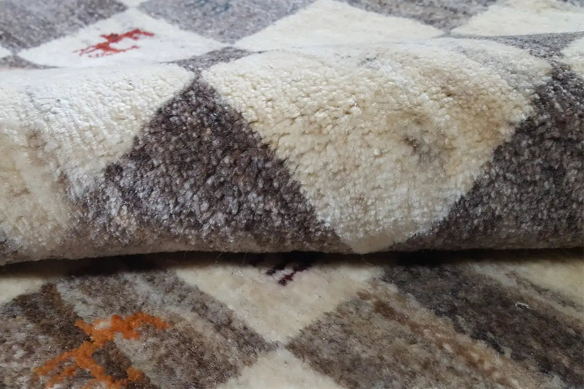 Gabbeh rug with beige and dark gray pile, pattern with colorful accents